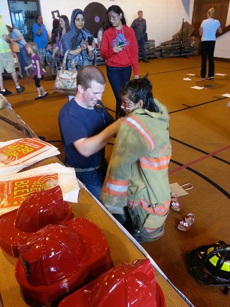 FF Desiderio helping a student get dressed.  