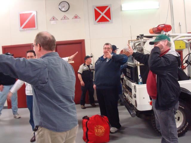 Deputy Chief John Carbo, in center, also practices traffic control hand signals.