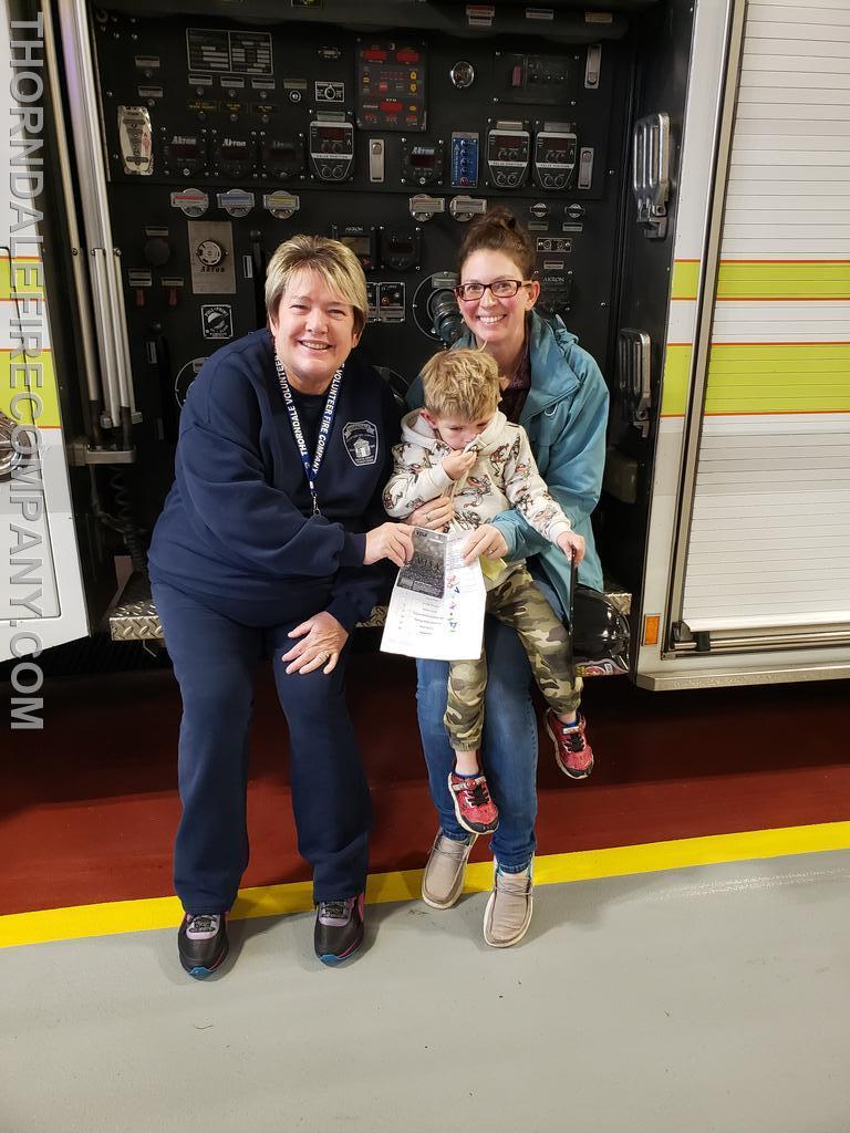 FF Mattson with Wesley Hill and his Mommy picking up the 50 dollar gift card they won.